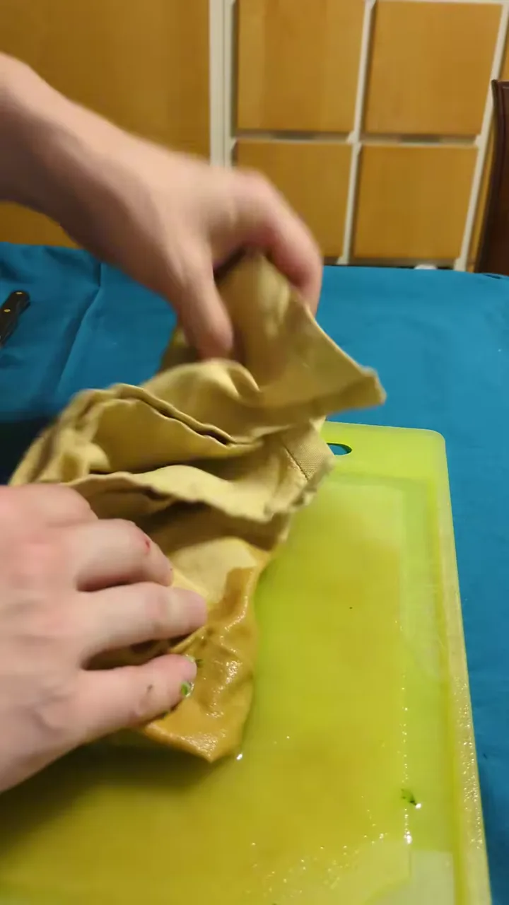 Grated cucumber being squeezed inside a cloth