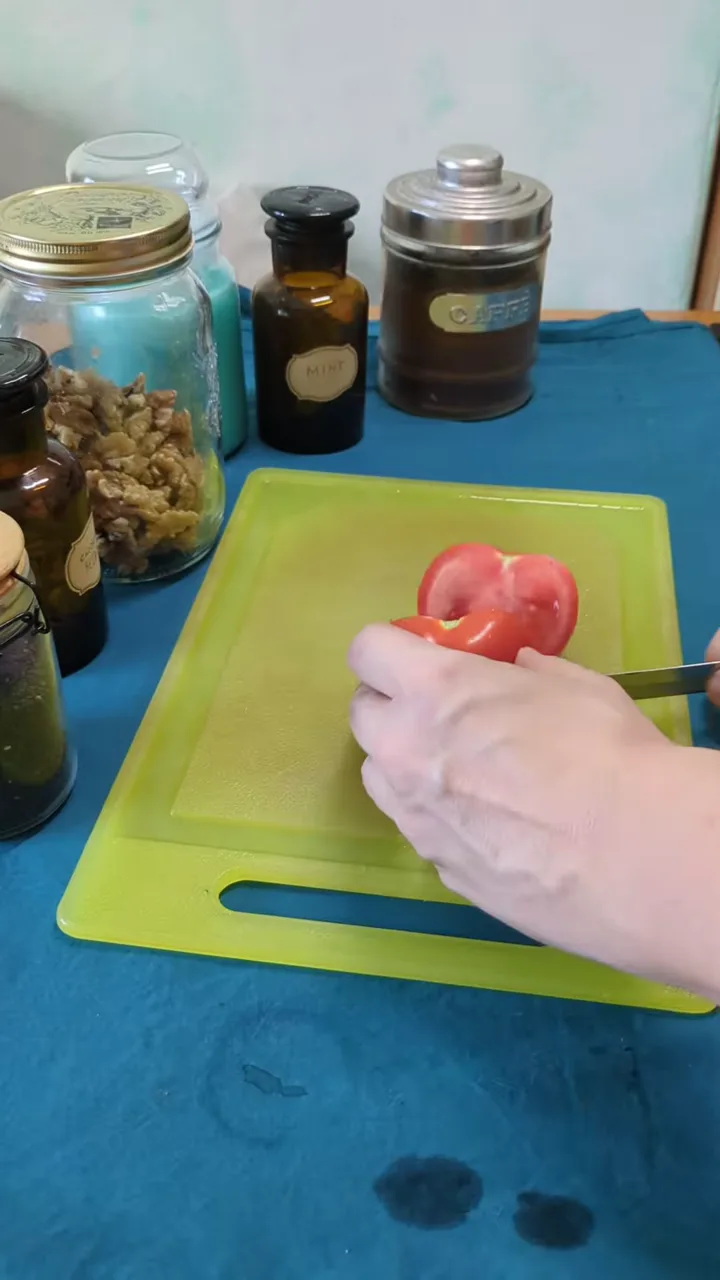 Tomatoes being diced on a cutting board